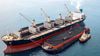 Photo depicts Loading Unloading Coal From Barge to Mother Vessel
