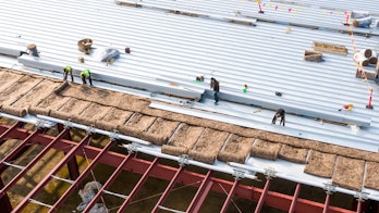 Construction Workers Installing Insulation And Roof Panels Usa Shutterstock 1929213377