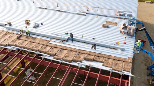 Construction Workers Installing Insulation And Roof Panels Usa Shutterstock 1929213377