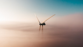 Cover Image Of Renewables 2022 A Photo Of A Wind Turbine Through Soft Hazy Clouds