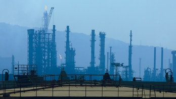Photo depicts Mumbai,Maharashtra,India,March, 03,2009: Silhouette showing cluster of tall chimneys,columns,towers,flare stacks, storage tanks,of petroleum