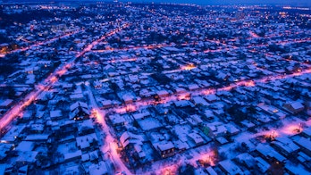 Evening aerial view to residential area Zhuravlivka in Kharkiv with snow, Ukraine